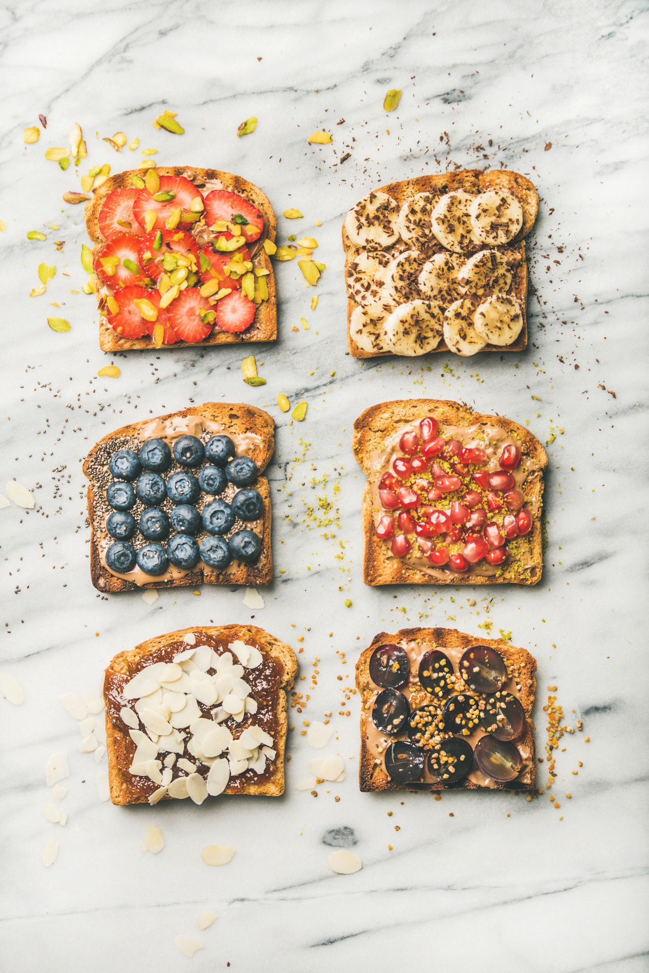 Vegan toasts with fruit, seeds, nuts and peanut butter