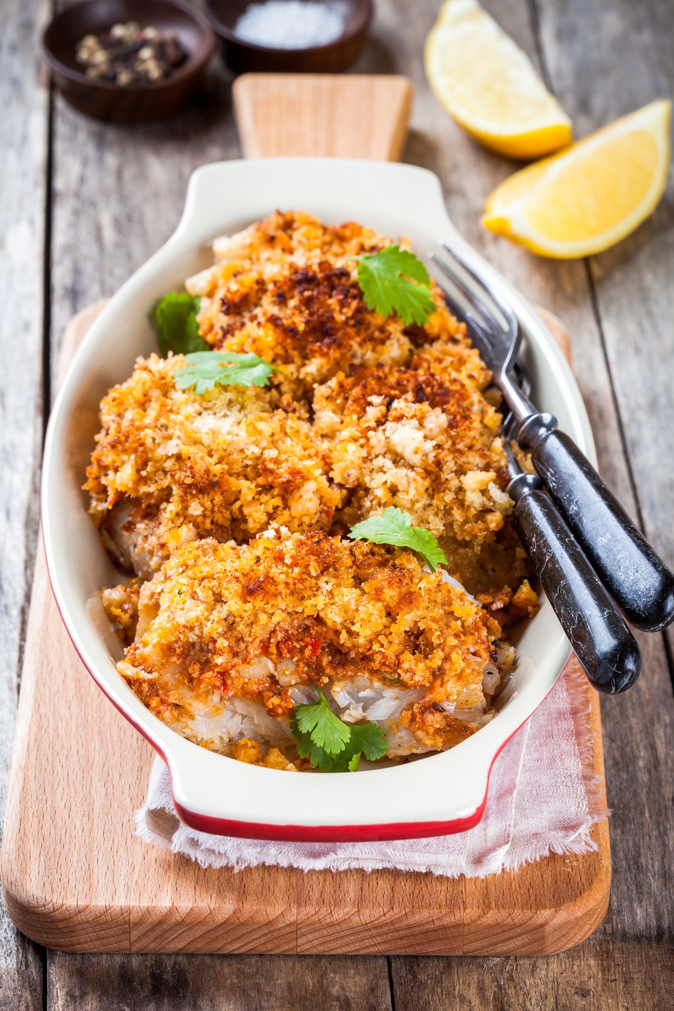 Baked cod fish in breadcrumbs in gratin dish